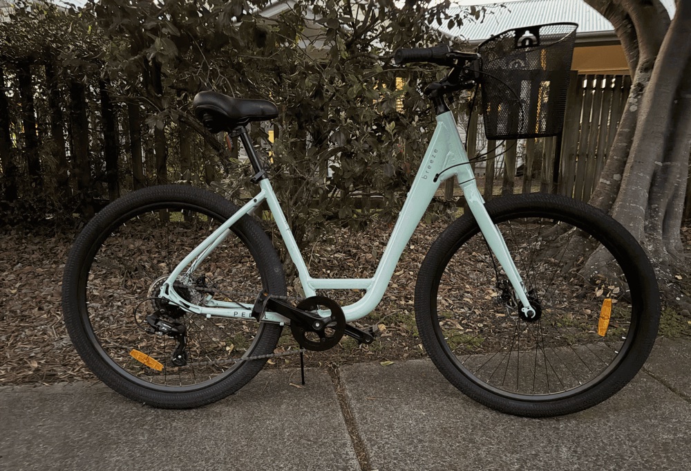 A mint green step-through beach cruiser, one of the bikes in the Kingscliff hire fleet